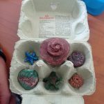 a box of DIY fossils made by a child